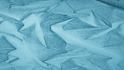 Blue foil texture with shiny metallic surface and wrinkled pattern, abstract luxury background for design and decoration.