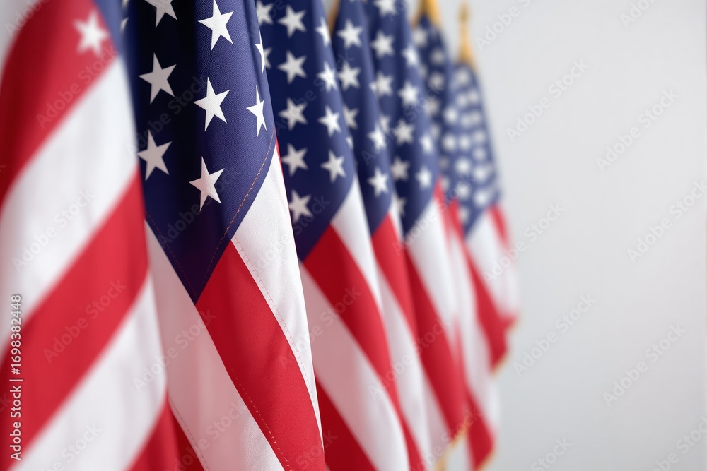 Poster multiple american flags displayed in a row, close-up angle with shallow depth of field, soft neutral