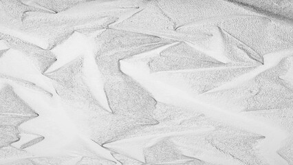 Silver foil texture with shiny metallic surface and wrinkled pattern, abstract luxury background for design and decoration.