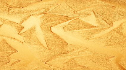 Golden foil texture with shiny metallic surface, abstract luxury background for design and decoration.
