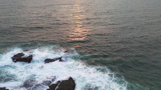 Dramatic Aerial Drone Push In Revealing Golden Sunset over Ocean and Cliff
