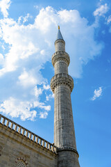 View of Blue Mosque or Sultanahmet minaret against blue sky with cloud, Istanbul, Turkey.