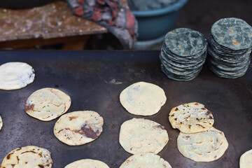 Traditional Corn Tortillas Cooking on a Hot Plate at a Street Market in Guatemala