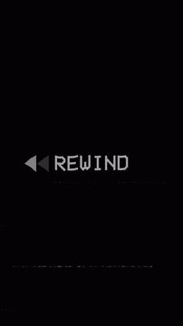 Analog TV displaying an old VHS rewind animation, with REWIND text, static noise, screen defects, and visible artifacts on a black background. 4K vertical video.