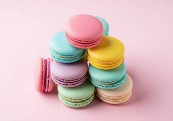 Obraz premium Colorful macarons stacked on a pink background