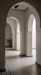 Fototapeta premium Elegant Moroccan Riad Hallway with Arched Entryways, Patterned Tiled Floor, and Decorative Elements