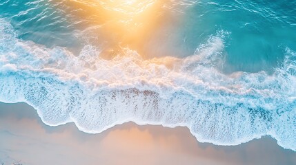 An aerial view captures the mesmerizing dance of ocean waves meeting the sandy shore, illuminated by the golden glow of the sun