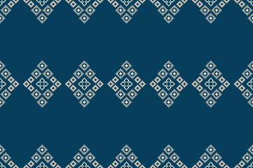 Blue color background with ethnic pattern traditional motif ikat geometric fabric pattern cross stitch.Ikat embroidery oriental pixel,abstract,vector ,texture.
