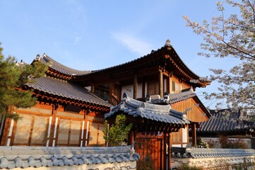Jeonju Hanok Village quiet side street in South Korea. Neighborhood of traditional Korean wooden architecture. View with spring time cherry blossoms.