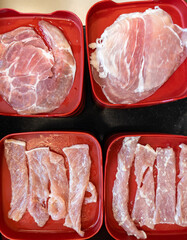 Fresh Sliced Pork Collar and Marinated Meat in Red Tray for Shabu Hotpot.