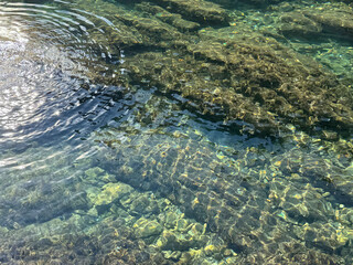 A calm lake surface reflective ripples peaceful, relaxing, gentle background. 