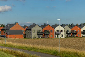 Fototapeta premium Vagnharad, Sweden A row of single-family homes on a field.