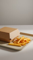 Burger box on a tray with fries