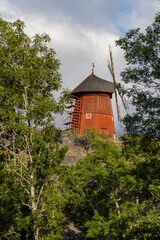 Trosa, Sweden A red windmill on top of a hill.