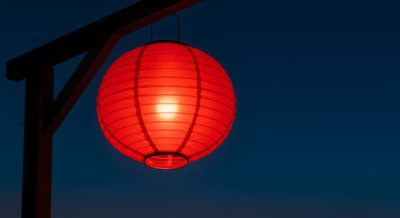 Obraz premium Radiant Red Lantern in Evening Sky: A solitary, vibrant red lantern gently illuminates the deepening twilight, casting a warm glow against the serene.
