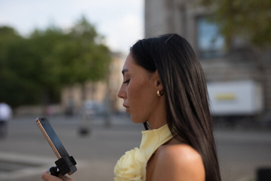 young woman using mobile phone in park