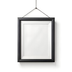 A single black gallery frame elegantly suspended by a metal chain on a plain surface