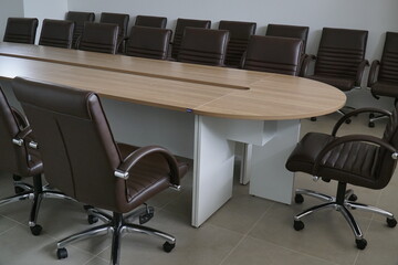 Large wooden table with many chairs around it