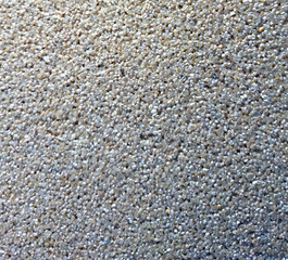 Close-up textured surface of small pebbles on a beach