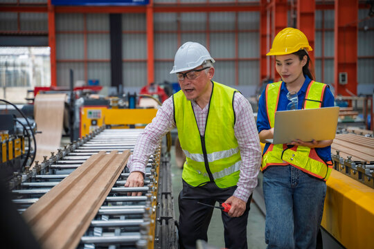 Engineer and technician inspecting materials on factory production line while discussing data on laptop. Great for industry, manufacturing, teamwork, and quality control concepts. - Powered by Adobe
