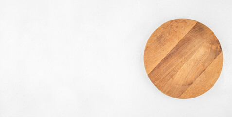 Empty round wooden cutting board on white background, top view, copy space