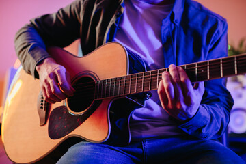 Obraz premium Musician composing music playing acoustic guitar at home