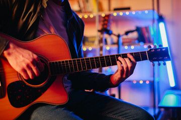 Obraz premium Musician composing music playing acoustic guitar at home