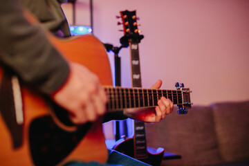 Obraz premium Musician composing music playing acoustic guitar at home