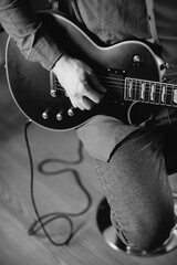 Musician composing music playing electric guitar at home