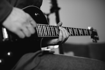 Musician composing music playing electric guitar at home