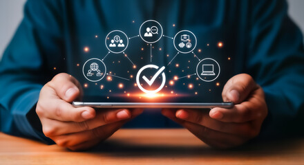 Business person holding a smartphone with a digital interface showing a network of icons and a central checkmark, symbolizing quality assurance and compliance