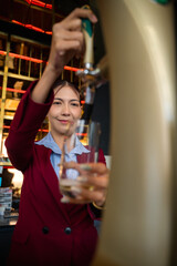 Asian bartendy mixologist making cocktail in bar