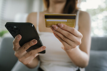 A woman uses her laptop for online banking and payments, managing finances, purchasing goods, transferring money, and exploring digital commerce.