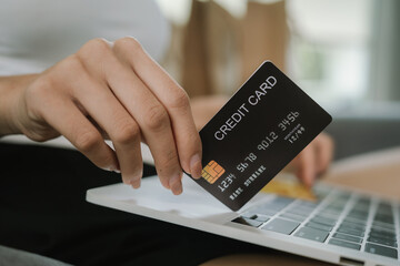 A woman uses her laptop for online banking and payments, managing finances, purchasing goods, transferring money, and exploring digital commerce.