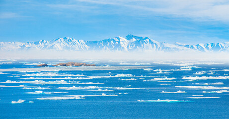 Melting icebergs by the coast of Greenland, on a beautiful summer day - Melting of a iceberg and pouring water into the sea - Greenland