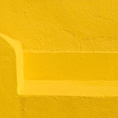 Yellow painted wall with a built-in bench