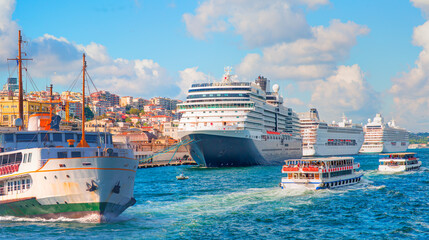 Cruise ship and ferry (steamboat) traffic in the Bosphorus - Sea voyage with old ferry (steamboat) on the Bosporus - Coastal cityscape with modern buildings under cloudy sky - Istanbul, Turkey 