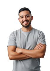 Obraz premium Young adult hispanic man (25-30) with short dark hair, beard, grey t-shirt, arms crossed, smiling confidently in a transparent studio, professional studio portrait concept