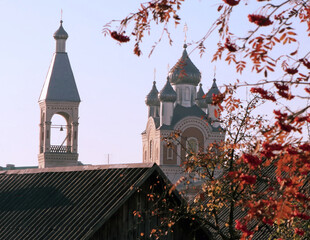 Architectural beauty of a historic church against a vibrant autumn backdrop in a small town
