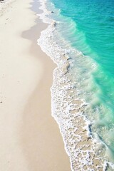 Fine, white sand stretches along a pristine shoreline, gently lapping waves creating delicate textures  Perfect for travel, nature, and coastal themed projects ,  serenity,  calm