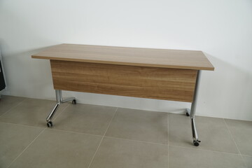 Wooden table with a black wheel on the bottom