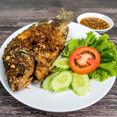 Crispy fried fish served with salad and sauce