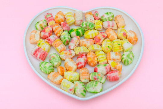 Sweet multi-colored sugar candies on a white background. Close-up.