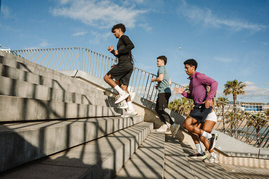 A group of five athletes running up the stairs - Powered by Adobe