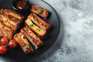 Closeup of pork ribs grilled with BBQ sauce and caramelized in honey.