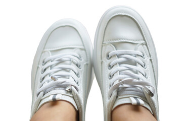 White sneakers on the girl's feet on a white background