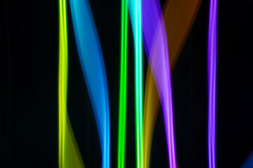 background irregular blue and neon lights on black background. Long exposure. Light painting photography