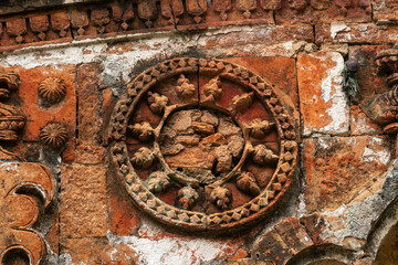 Intricate circular stone design in ancient architecture with detailed carvings