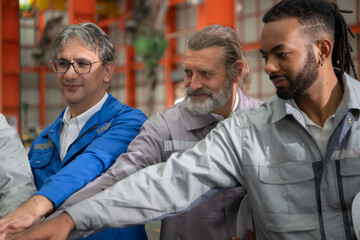 Fototapeta premium Group of Industrial worker inspecting inside a large metal tube in a factory
