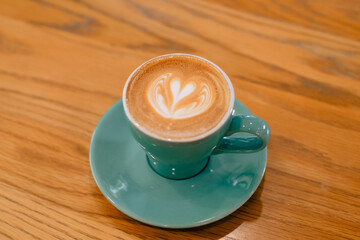 Latte art coffee in a blue mug